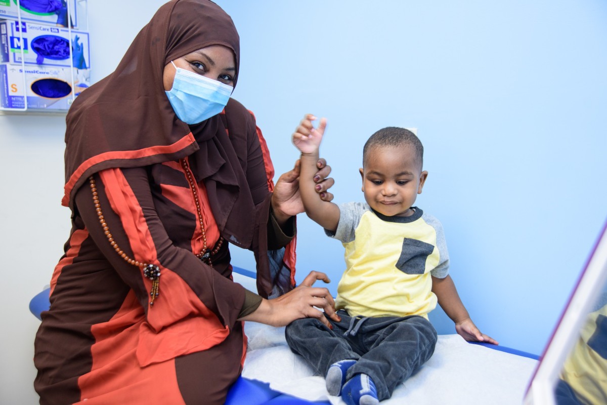 A medical professional with a happy toddler