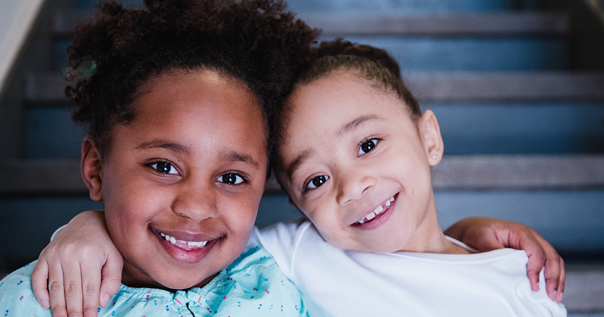 Two young children smile