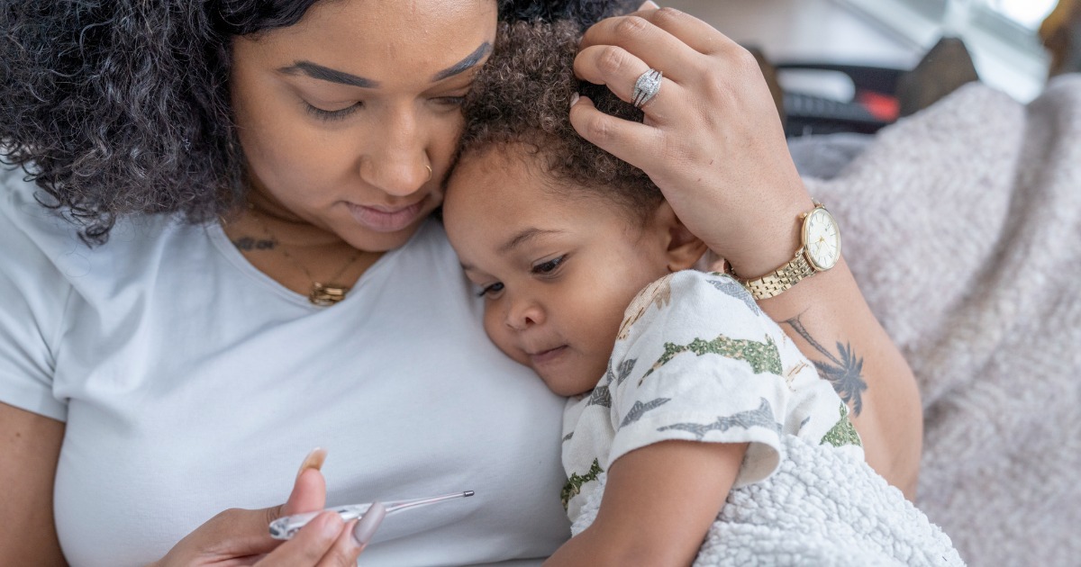 Mother snuggles her sick child