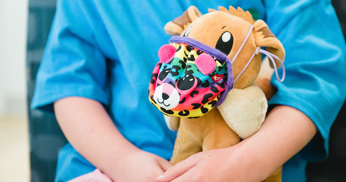 A child holds a stuffed animal