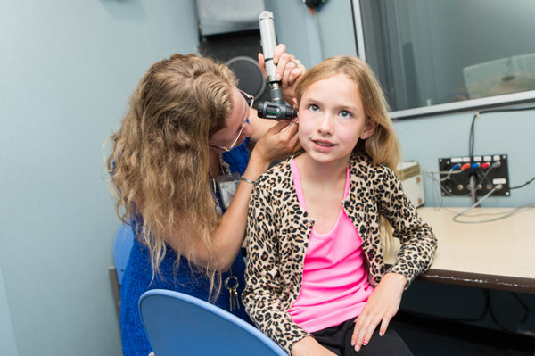 Otoscope being used