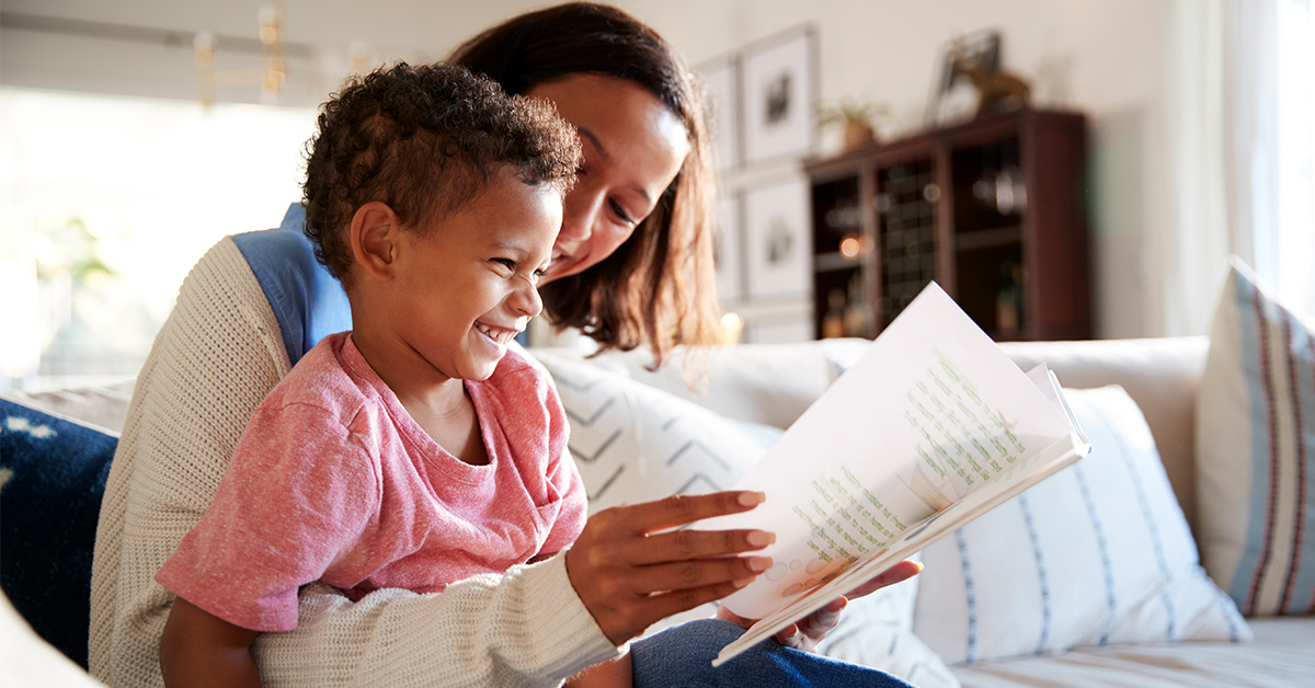 A mother reads a book with her son