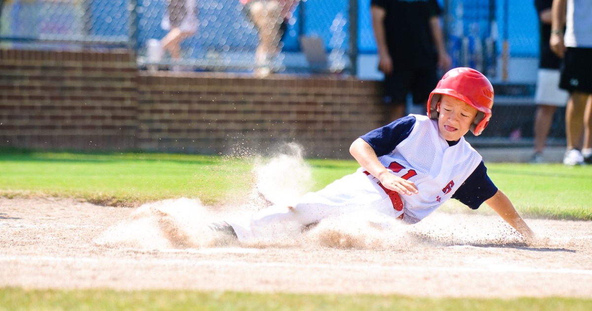 Boy sliding in baseball