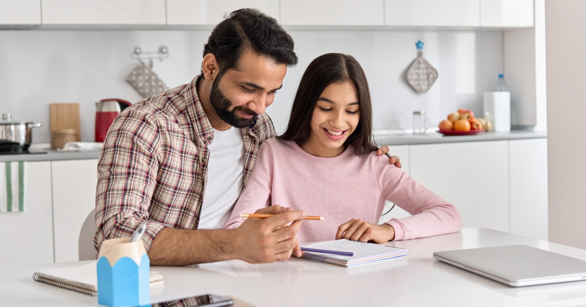 A father helping his daughter with homework