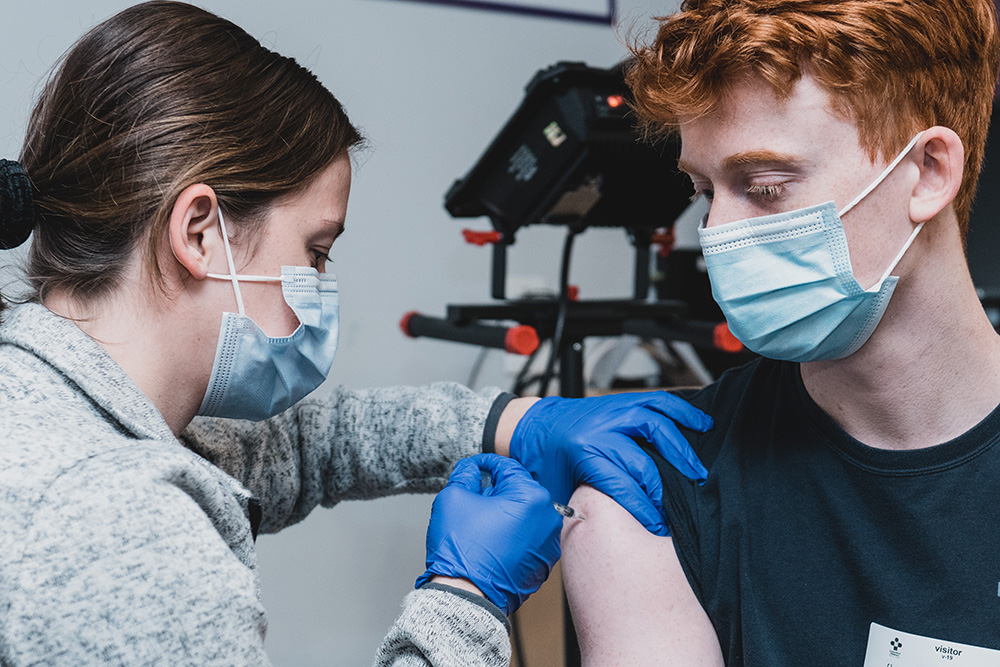 Teen getting a COVID vaccine