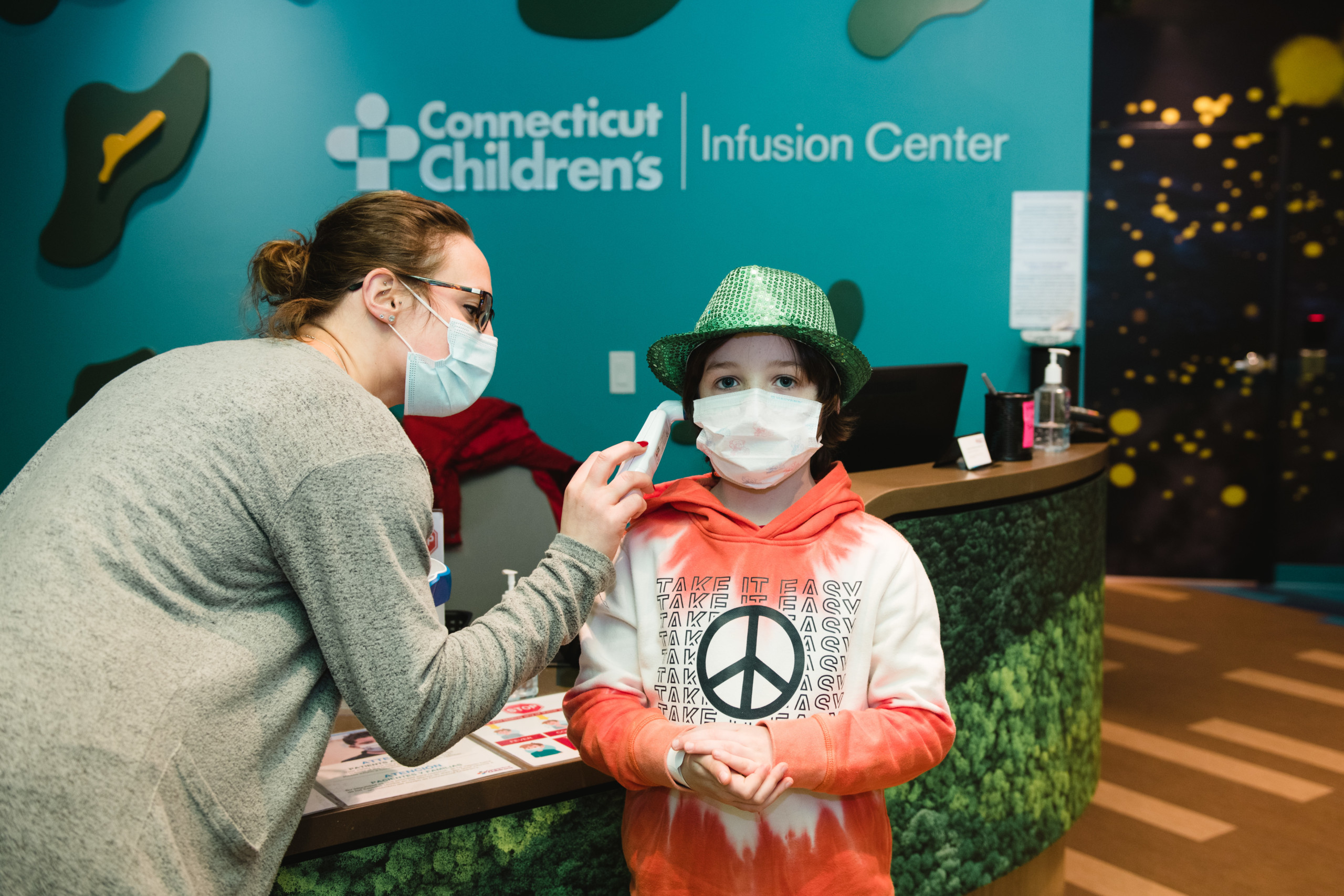 A child getting their temperature checked