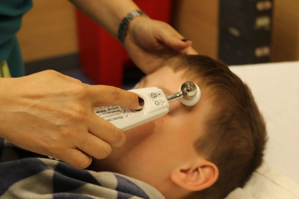 nurse checking patient's temperature