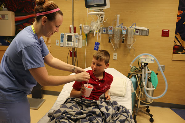 nurse giving patient slushy after procedure