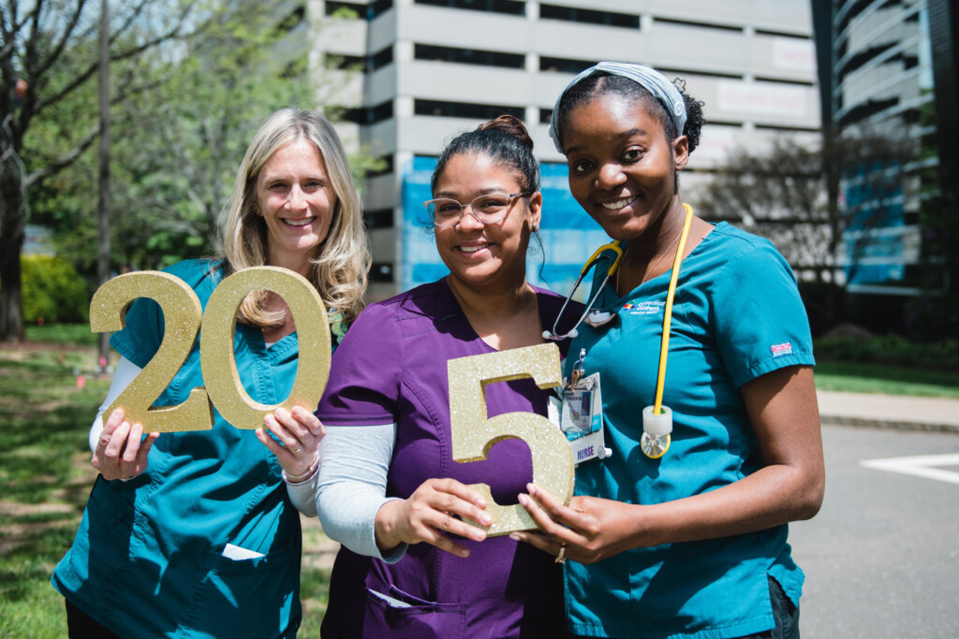 three team members celebrating anniversaries