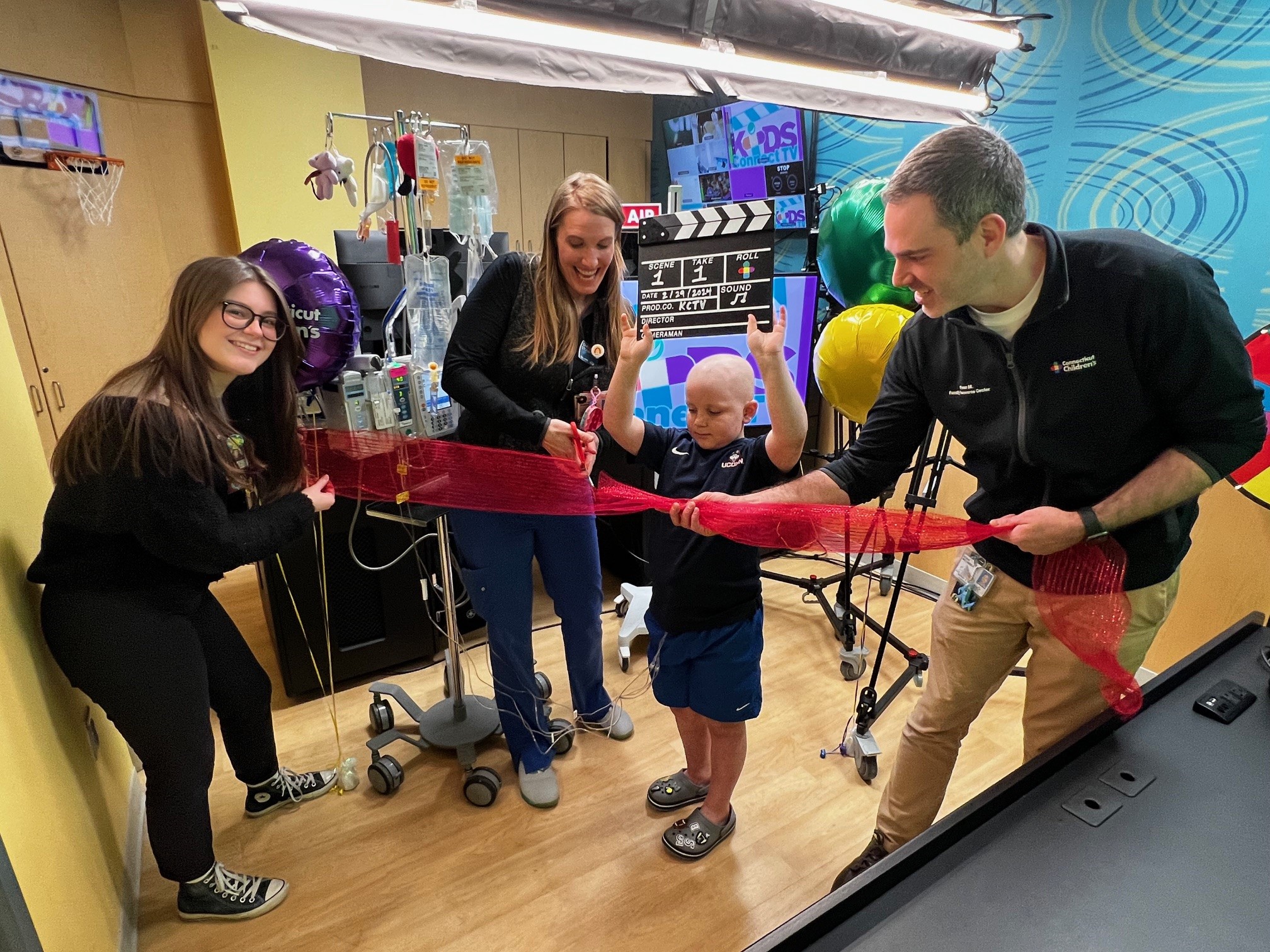 Ribbon cutting with patient at the new studio in the Family Resource Center