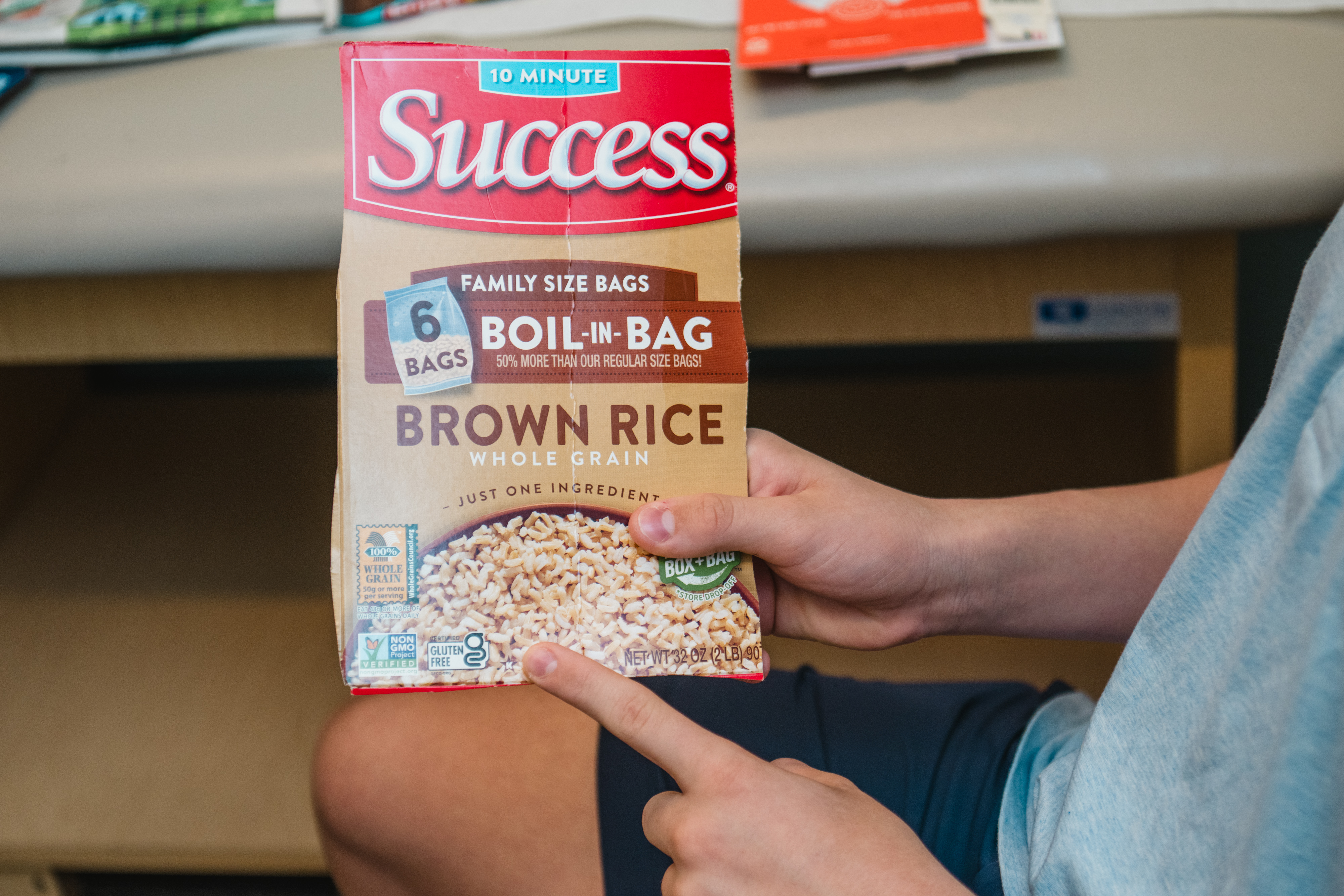 Hands holding a box of rice labeled Success