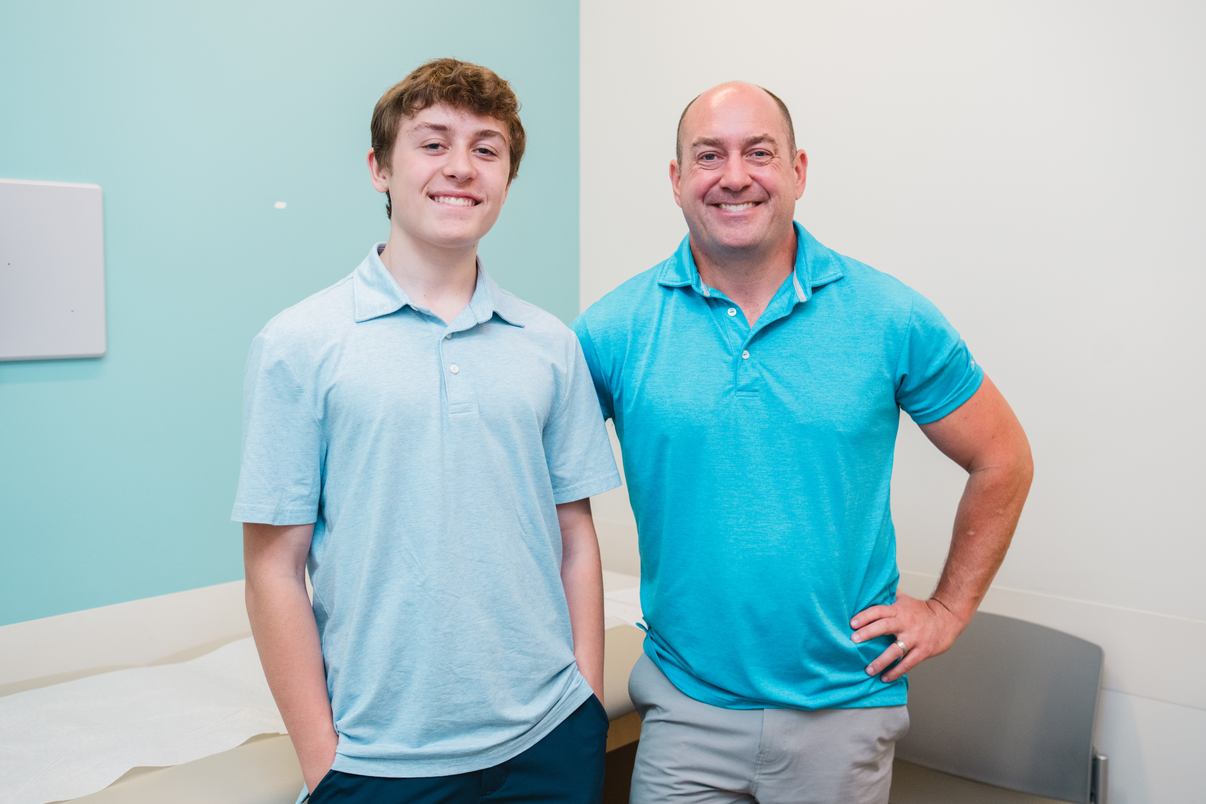 Teenage boy with celiac disease, posed next to his dad