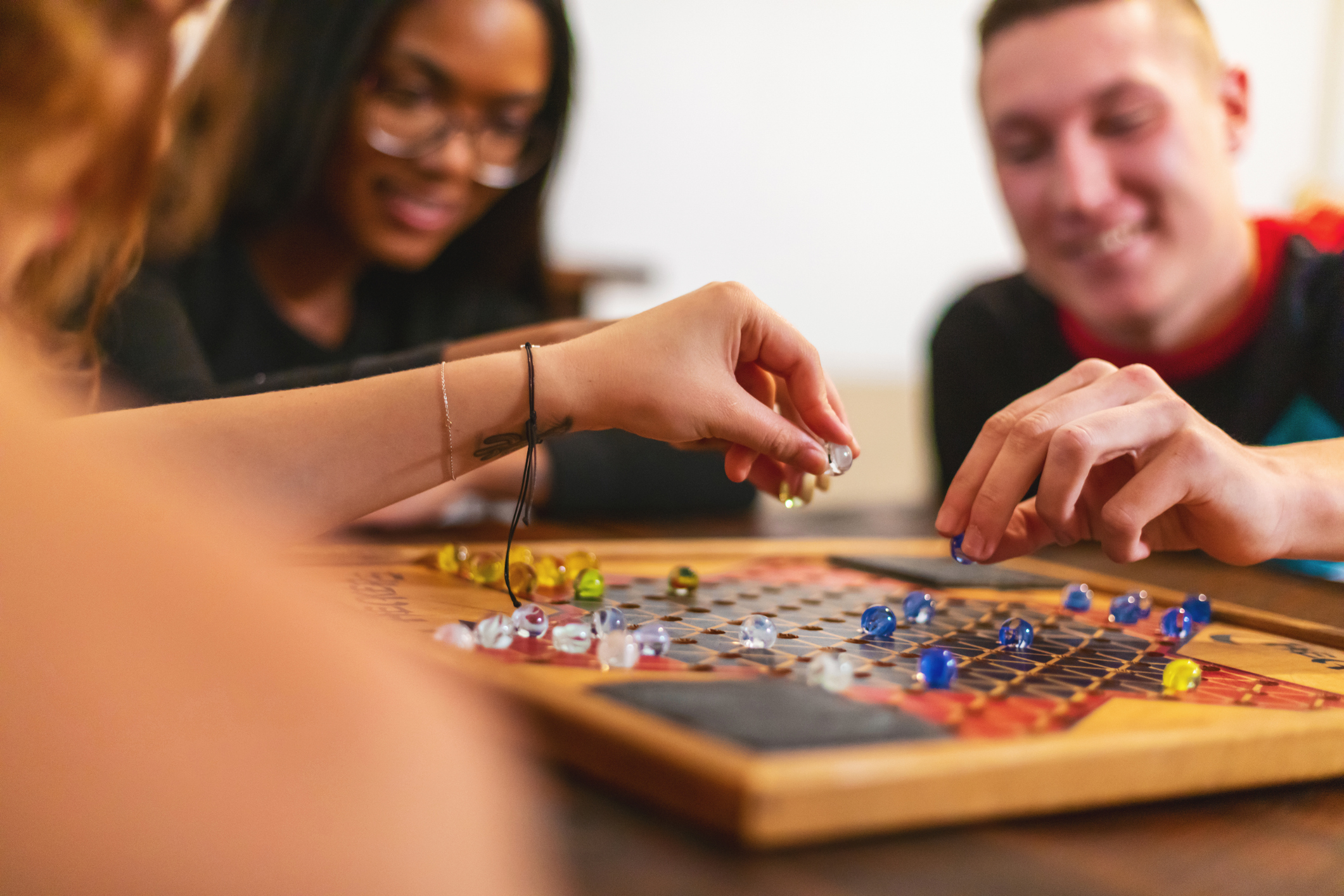 Teens playing a board game together