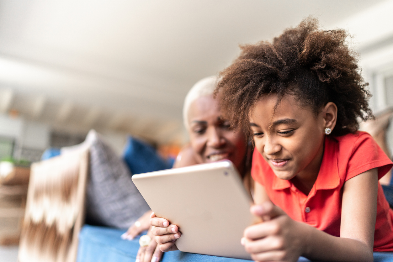 Child using iPad with mom