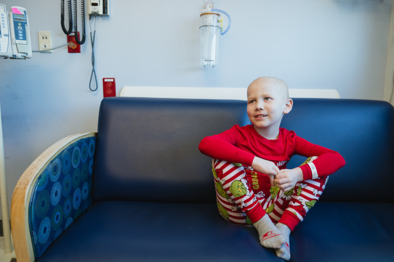 Child in hospital room, wearing holiday pajamas
