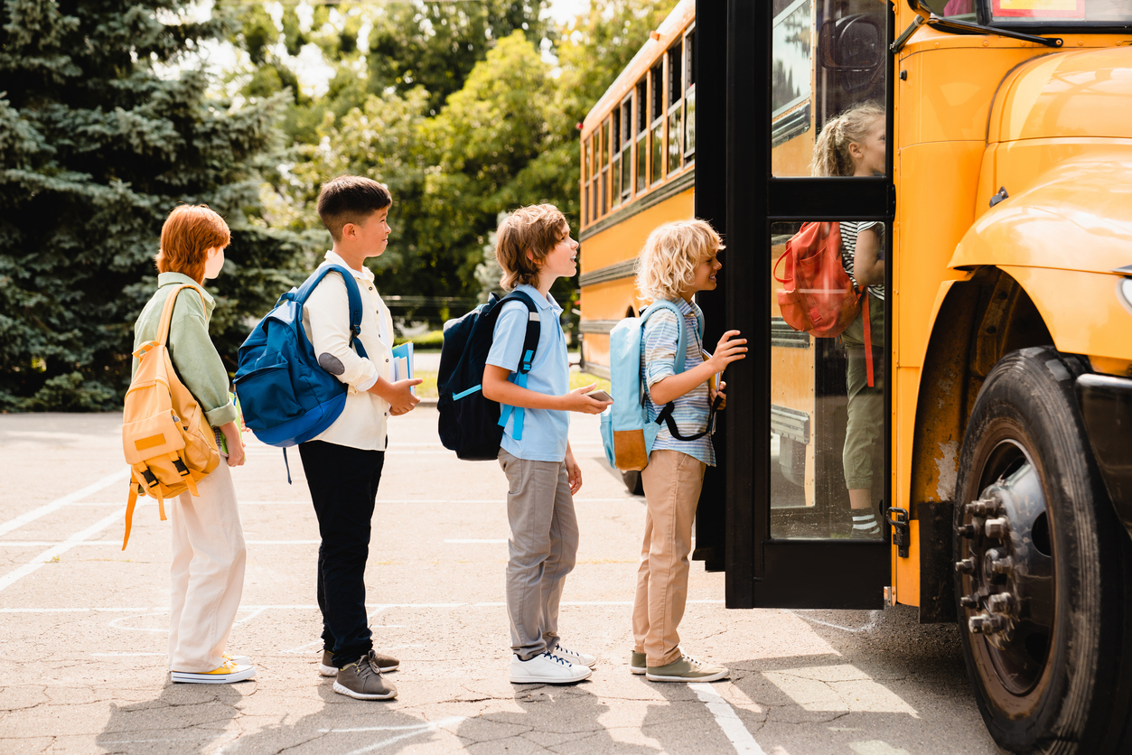 Kids getting on a school bus