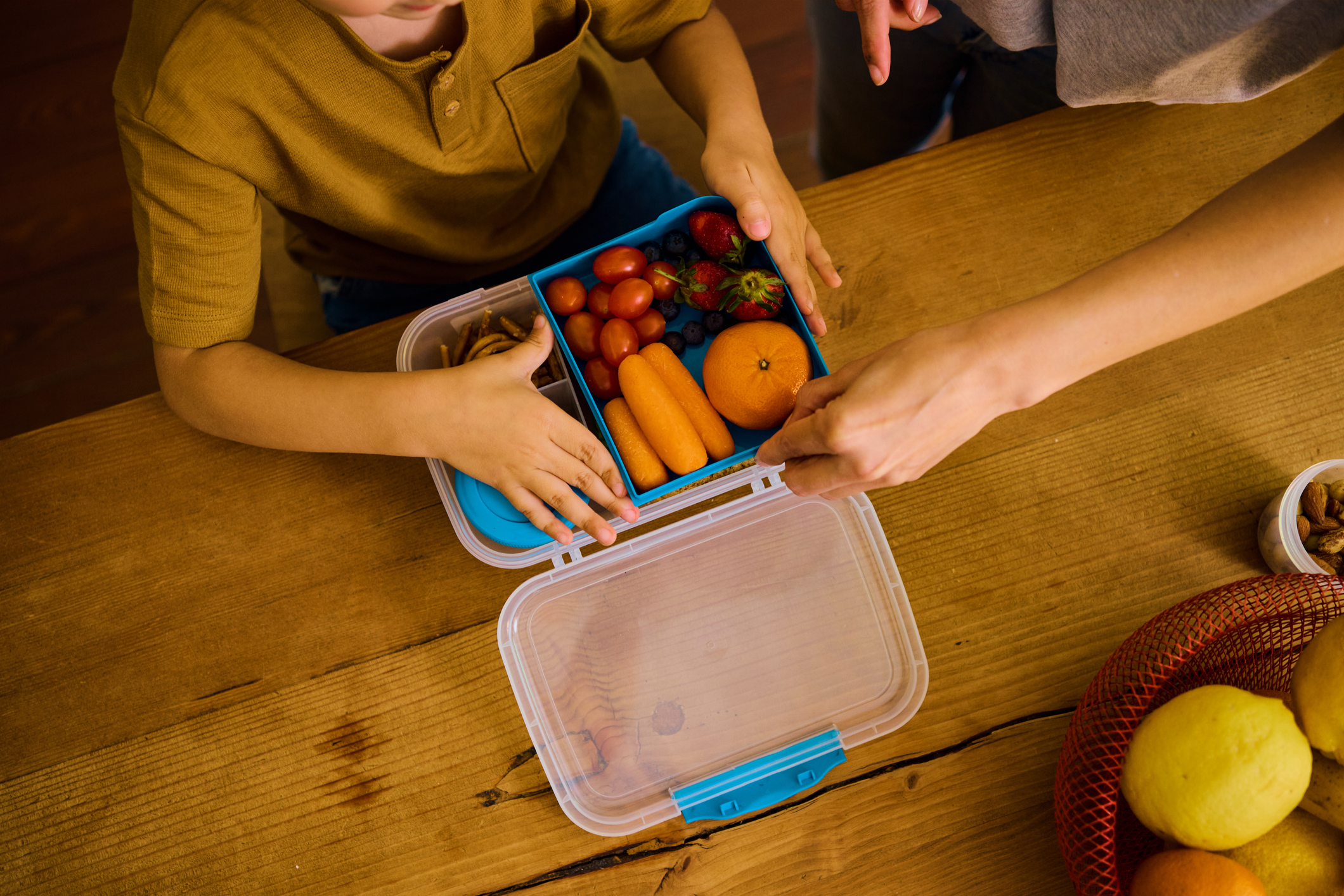 Child with healthy foods in lunch box