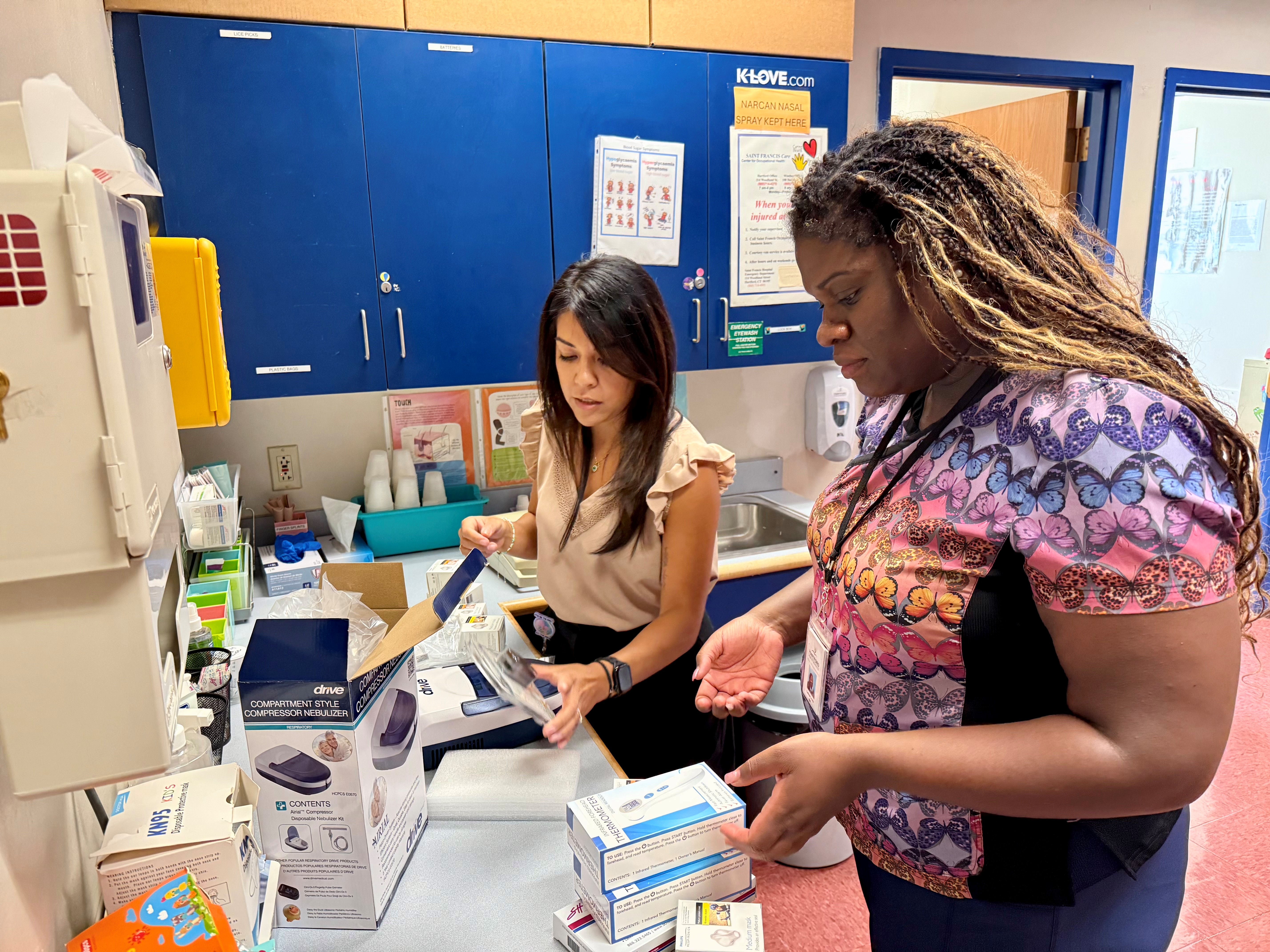 Sigrid Almeida, Easy Breathing for Schools delivering supplies to Latoya Lewis, School Nurse at WISH Elementary 