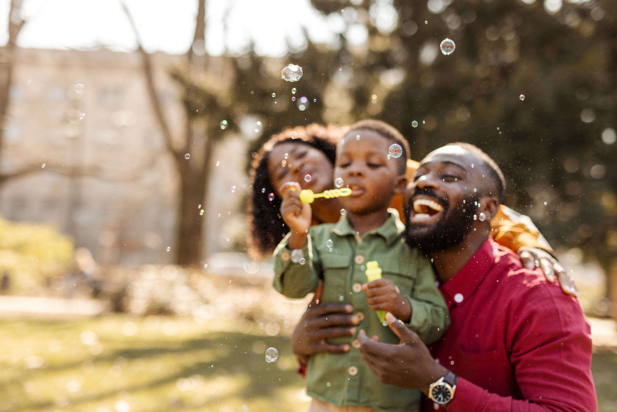 Family pblowing bubbles outside