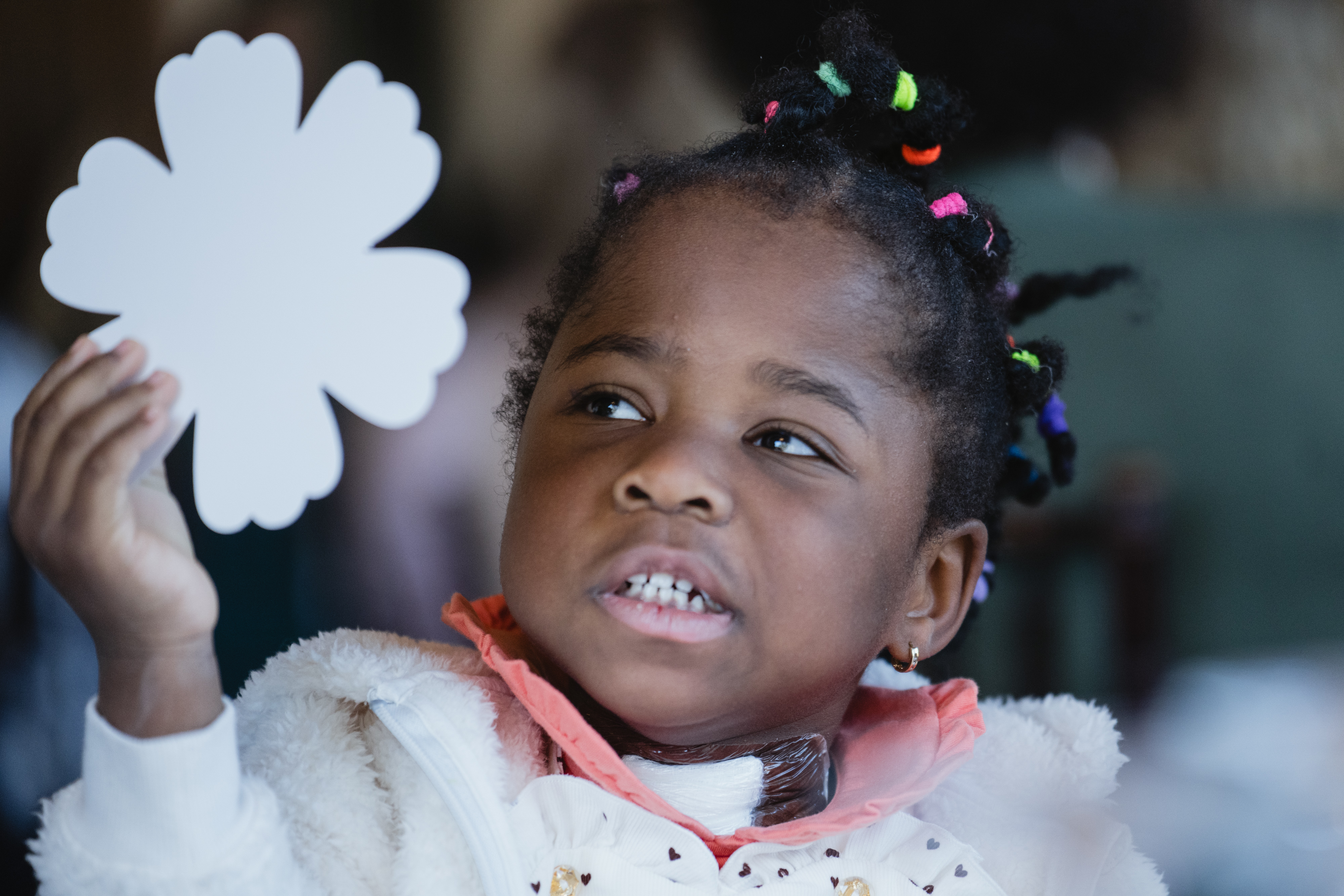 Adorable girl toddler holding a shamrock cutout. Was once extremely premature, now thriving 