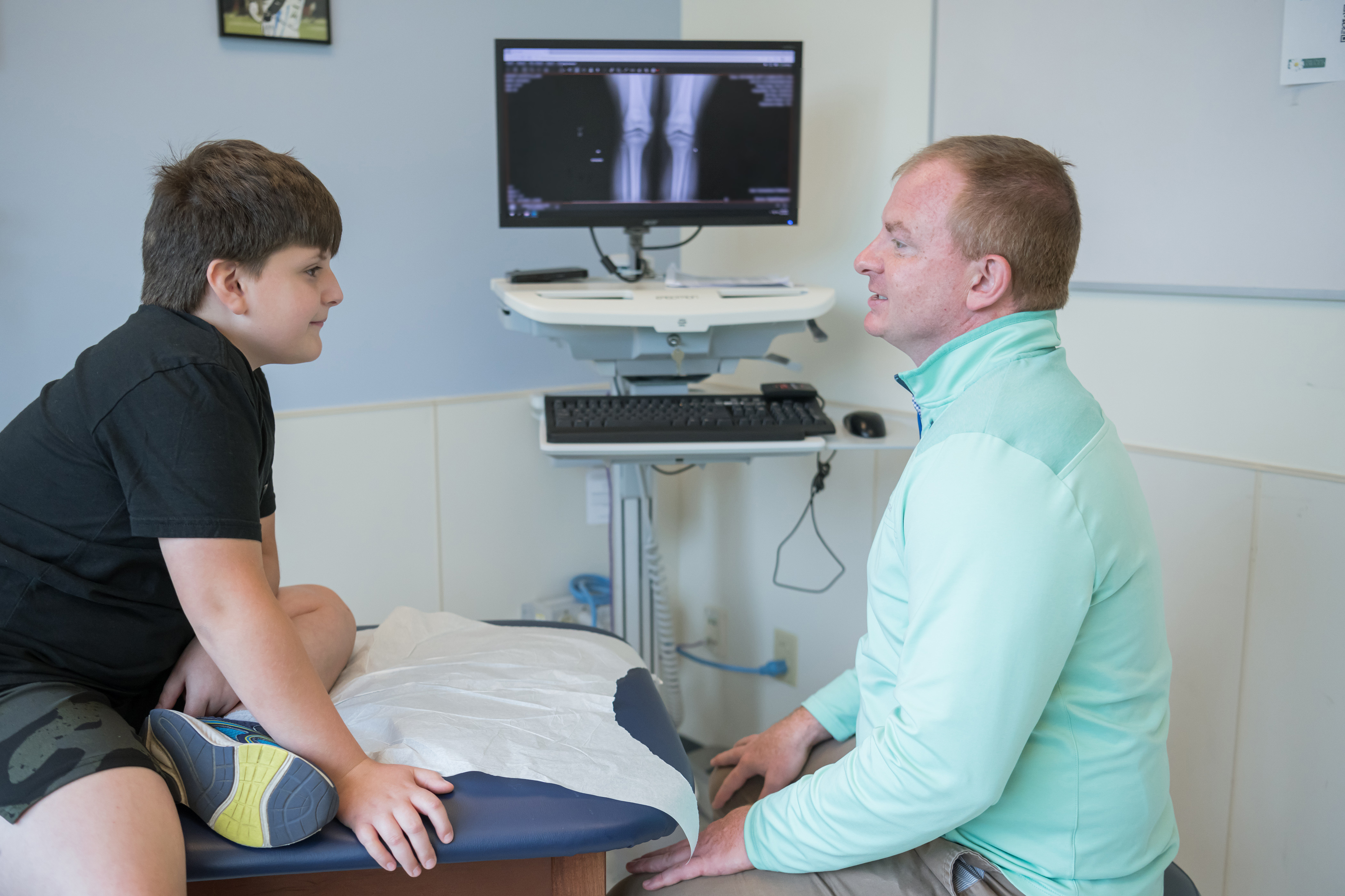 Provider treating Patient in Sports Medicine Department