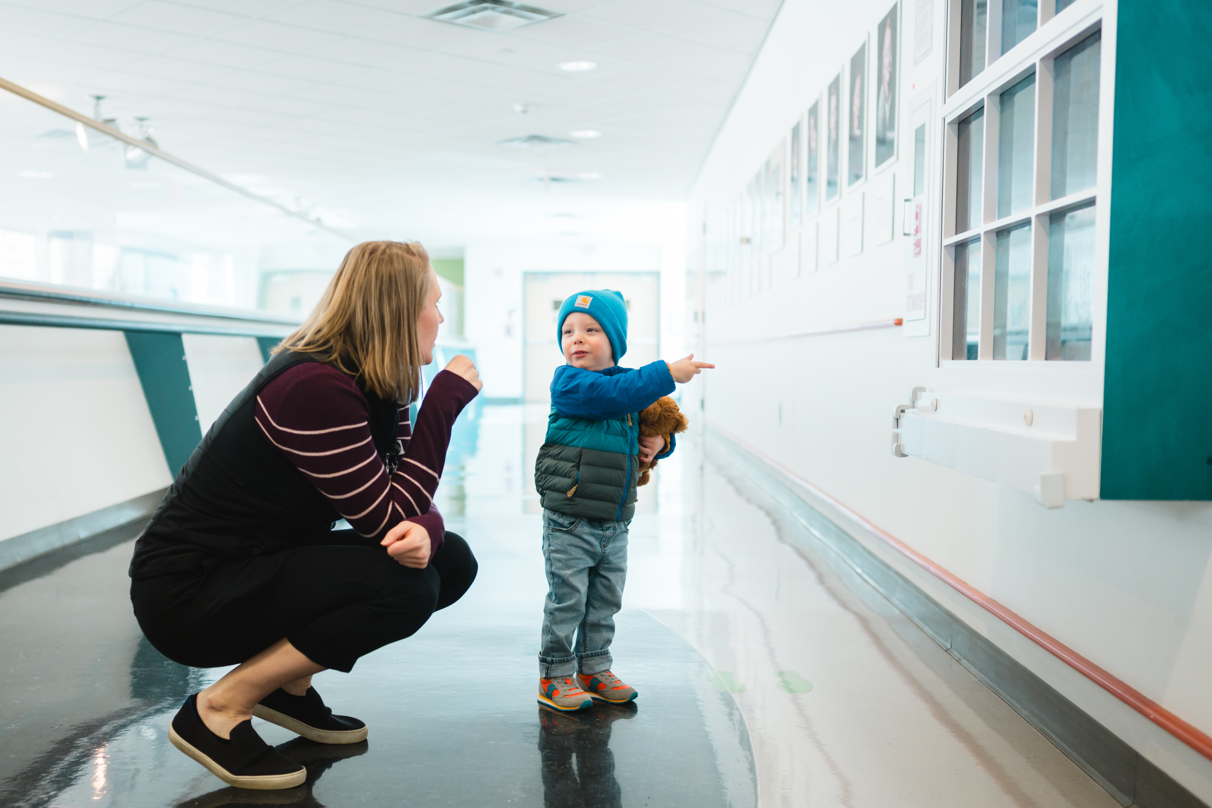 A patient interacts with a child life specialist and a Disney magic window.