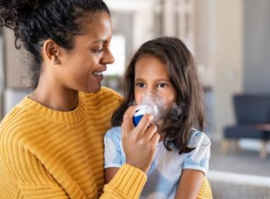 Mother helping her daughter use a nebulizer