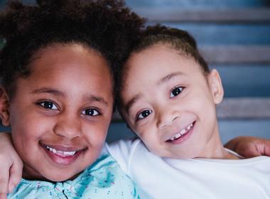 Two young children smile