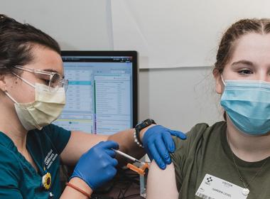 A teen getting a flu shot
