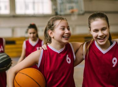 2 young teens on a basketball court