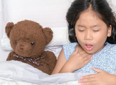 Young girl coughing