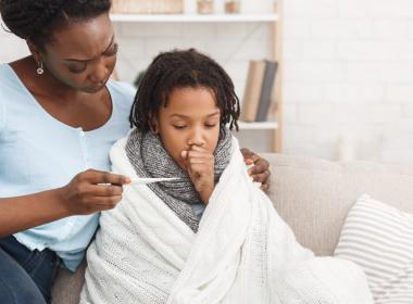 Mother measuring daughters temperature
