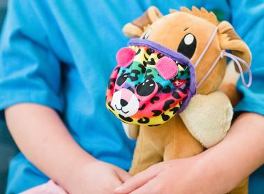 A child holds a stuffed animal