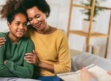 Mother and teenager daughter talk with therapist