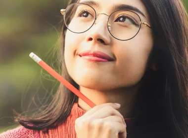 Young women holding a pencil