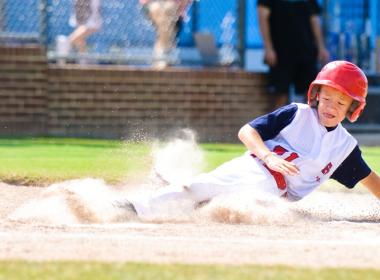 Boy sliding in baseball