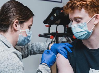 Teen getting a COVID vaccine