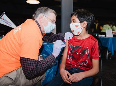 Young boy getting his COVID-19 vaccine
