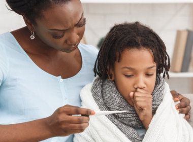 Mom taking her son's temperature, fever
