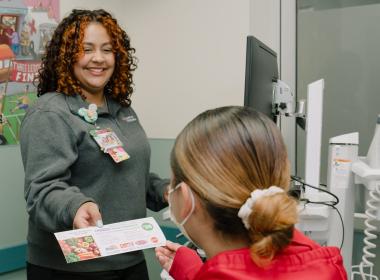 A patient being handed a food voucher in Connecticut Children's ED.