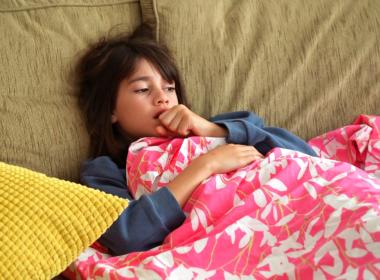 young sick girl coughing on couch. is it mycoplasma pneumonia?