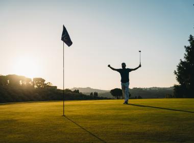 Person celebrating on a golf course