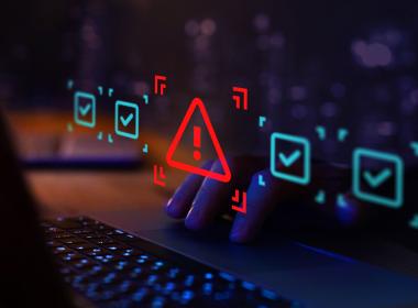 Laptop keyboard closeup with lit-up warning signs. Don't blow up Chromebooks at home