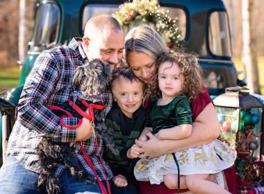 Young boy with little sister, mom, dad and dog
