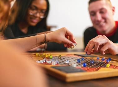 Teens playing a board game together