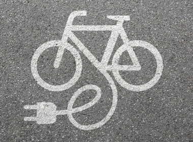 Chalk illustration of an electronic bike on pavement. E-bike injuries are rising fast