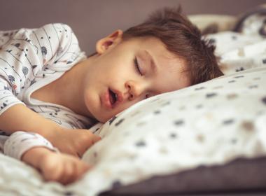 Young boy asleep in bed with mouth open, maybe mouth breathing