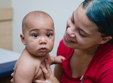 Mom smiling at baby in an exam room