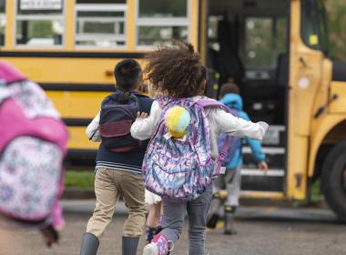 Kids getting on a school bus