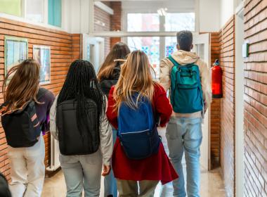 High school students walking don hallway